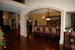 Arch design in lobby with wooden flooring and traditional dining furniture