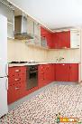 Red cabinets in the kitchen offer warm welcome