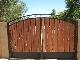 wrought iron gate with wooden stripes in the main gate design