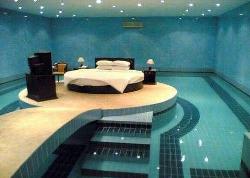 Bed in the middle of Swimming Pool Interior Design Photos