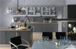 Modular kitchen design with cook top and hood at the center of the kitchen Interior Design Photos