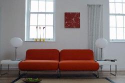 Rust Color Sofa for living room with wooden windows and Lamp for lighting Interior Design Photos