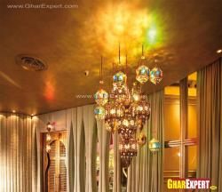 Decorative golden hanging light fixtures of different sizes Interior Design Photos