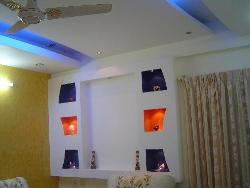 Living room false ceiling with colorful alcoves Wardobe with colourful mica