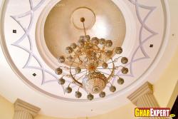 Ornamental chandelier with plaster of Paris design on cove ceiling Sand faced plaster
