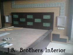 J R Brothers Interiors bed design with decor on the back wall Diwan back