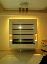 Backlit high glow LCD unit design for a living room done with white laminates Interior Design Photos