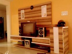 tv wall unit design covering entire wall with place for Music system and DVD player Covered balcony