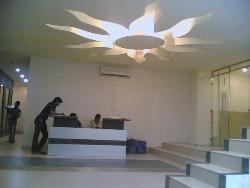 Sun shaped ceiling design in a reception Sun maika almirah
