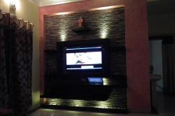 LCD TV wall with dark color stone cladding Stone farce designs