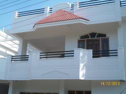 A Duplex house ,Balcony with Sloped roof &Wooden door/window frames Roof parda