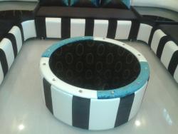 A designer center table custom made by Interior Designer to match the sofa Matching cot 