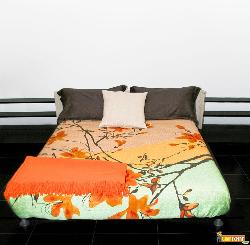 Bedroom with big double bed and colorful sheets Mgr sheet