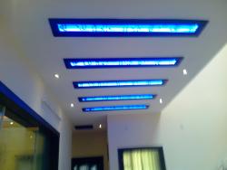 Ceiling design for a Lobby area with blue cove lights covered with glass Blue sexy