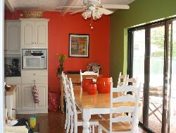 Dining Table  red colored wall Interior Design Photos