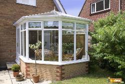 Conservatory tables chairs plants room in house next to garden Interior Design Photos