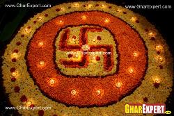 Flower arrangement represents swastik with diyas on ganesh chaturthi Fornt main loha gatein ganesh and laxmi murti