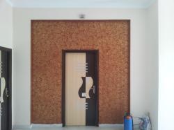 mica door in textured wall  of upper portion of door wall